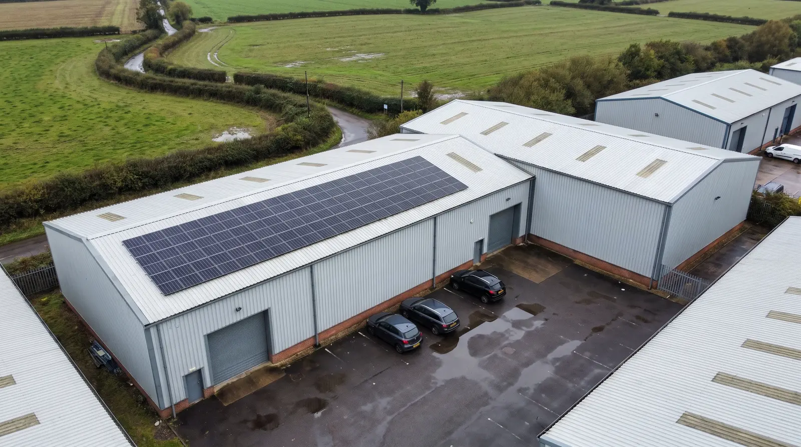 Aerial view of business units with solar panels on one roof